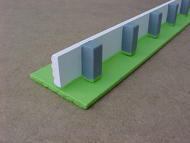 Rear of crash barrier with Armco front and concrete posts